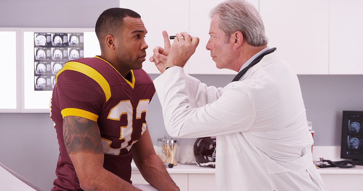 doctor examining football player