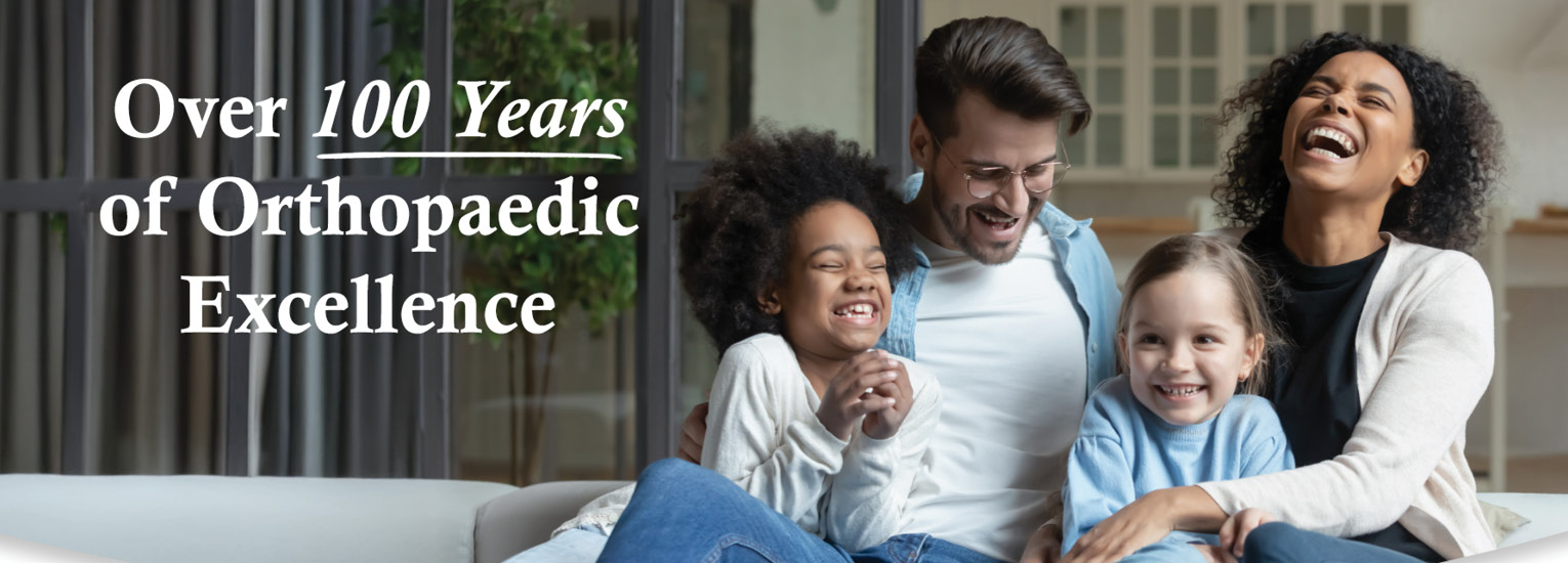 Over 100 Years of Orthopaedic Excellence: Interracial family laughing together