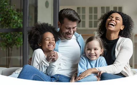 Interracial family laughing together