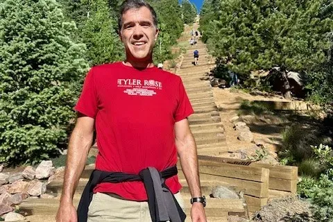 Christopher hiking up a trail