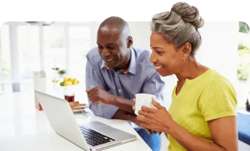older couple browsing on a laptop