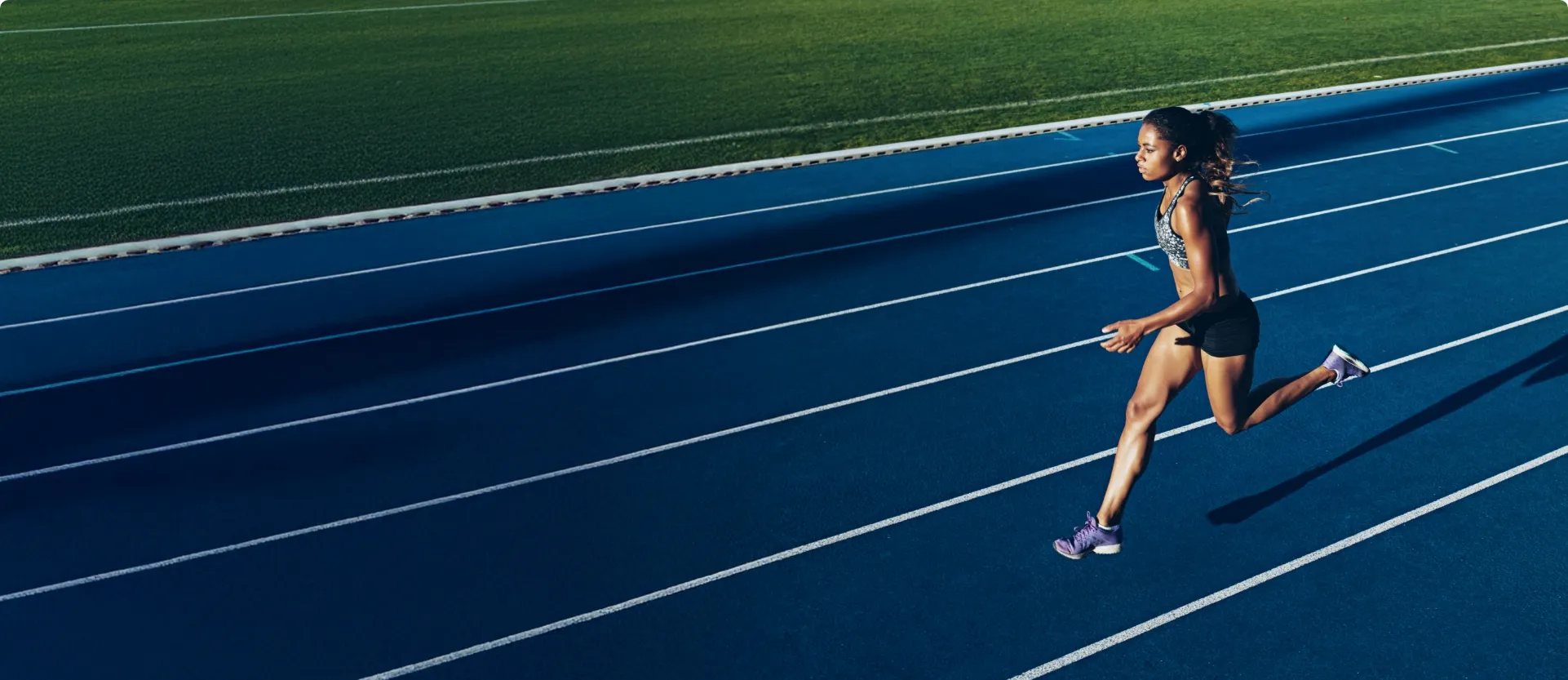 young woman running on a track