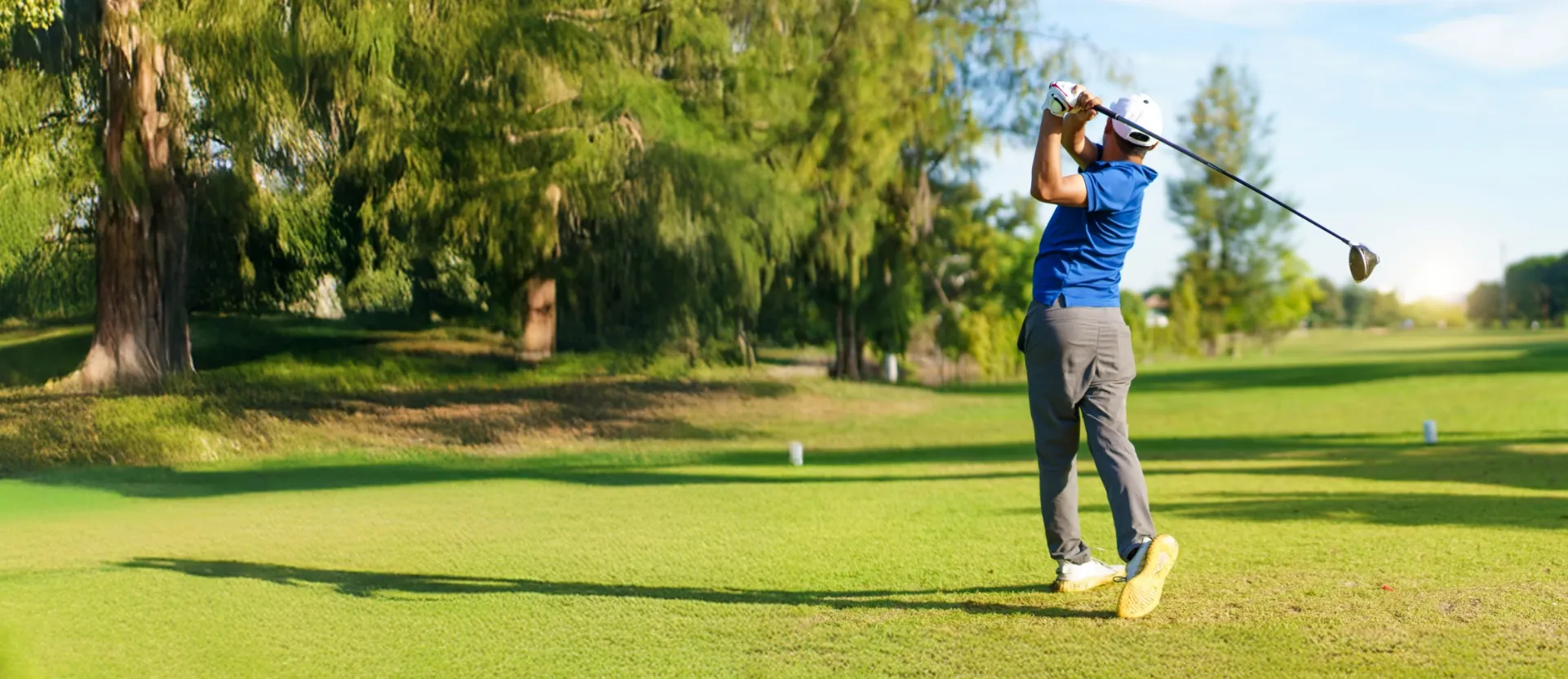 man in mid-golf swing