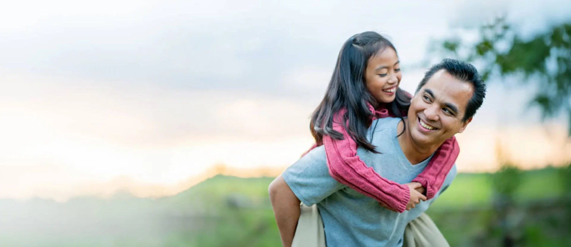 father carrying daughter outside