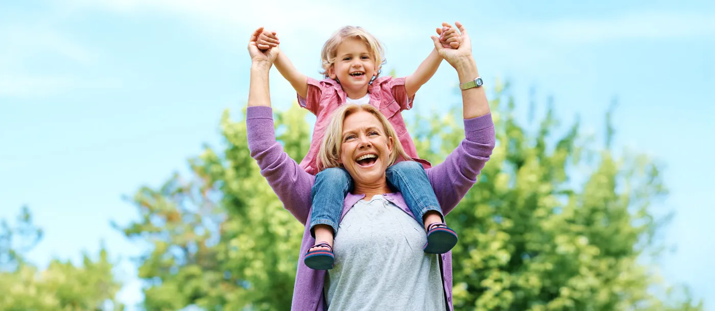 mother playing with her daughter outdoors