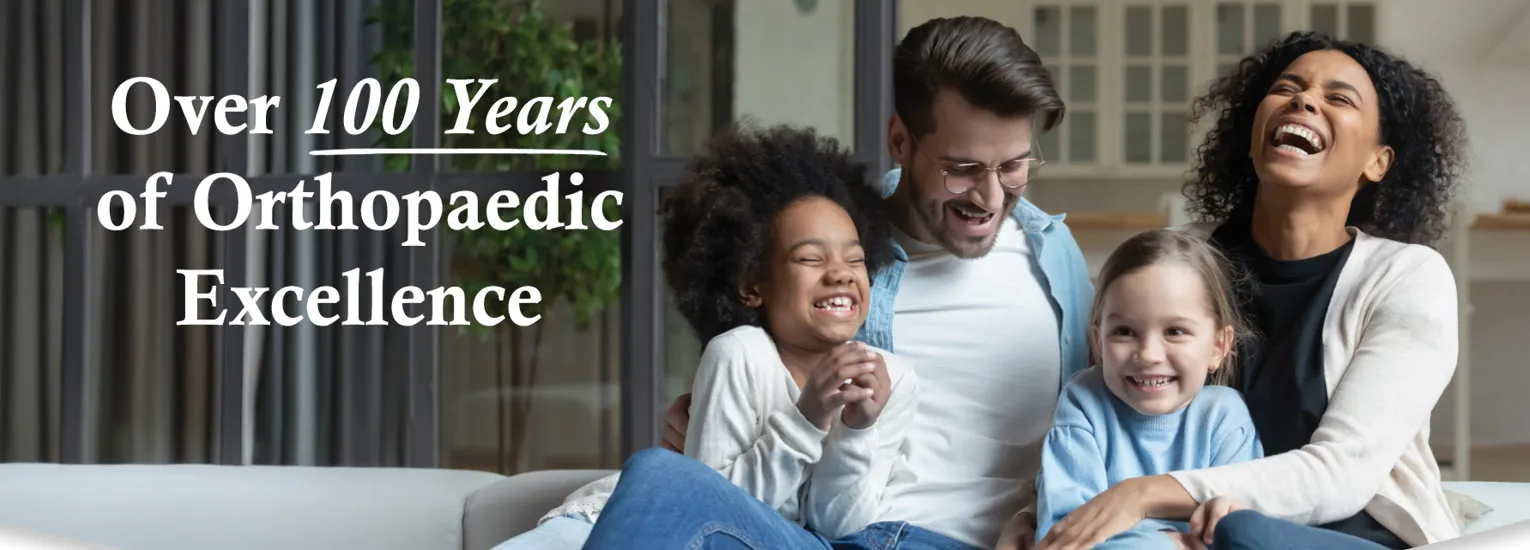 Over 100 Years of Orthopaedic Excellence: Interracial family laughing together